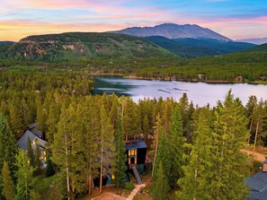 A mountainous landscape with a lake, forested area, and a cabin with a deck. - A-Frame + Hot Tub + Arcade + BBQ | Forest Views + Ski Access | Pitch & Pine (Breckenridge)