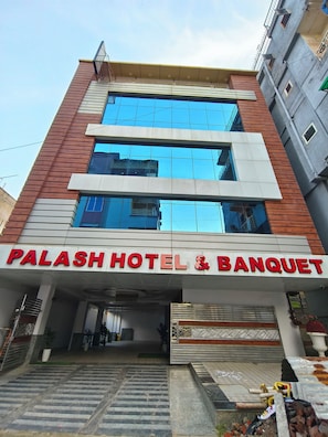 A hotel with a modern facade, large windows, and a prominent sign reading 'PALASH HOTEL & BANQUET'. - HOTELPALASH (Danapur)