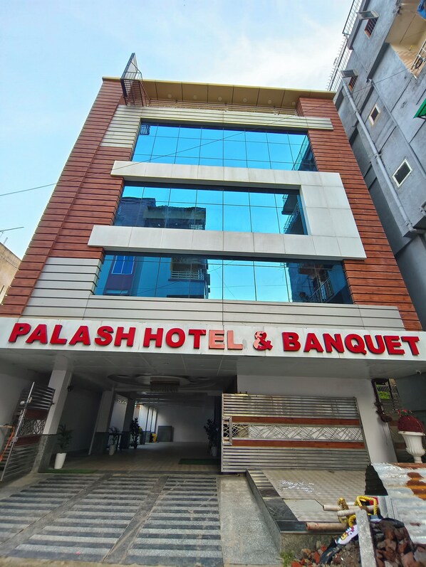 A hotel with a modern facade, large windows, and a prominent sign reading 'PALASH HOTEL & BANQUET'. - HOTELPALASH (Danapur)