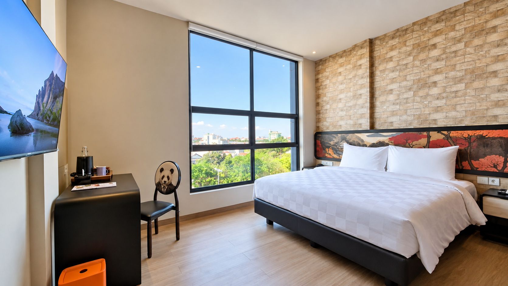 A modern hotel room with a large bed, a desk, a chair, and a large window offering a city view.
