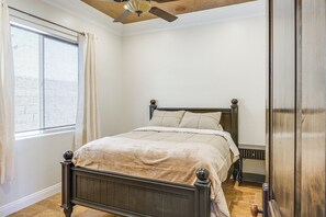A bedroom with a bed, a window with curtains, a ceiling fan, and a wooden floor. - Bakersfield Guest Suite, 11 Mi to Dtwn! (Bakersfield)
