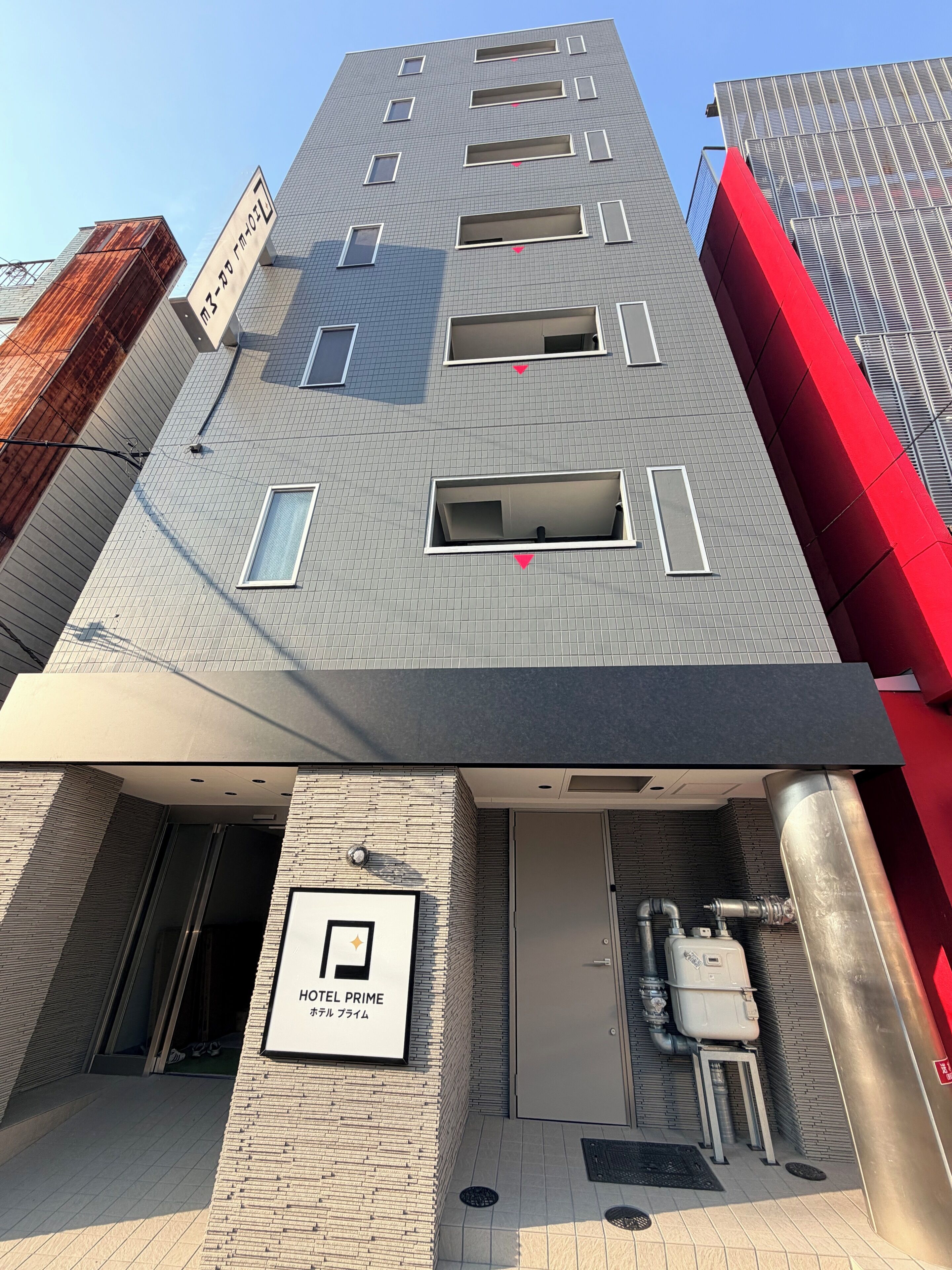 A modern building with a sign indicating a hotel named 'HOTEL PRIME'.
