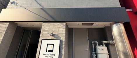 A modern building with a sign indicating a hotel named 'HOTEL PRIME'.