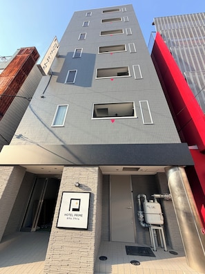 A modern building with a sign indicating a hotel named 'HOTEL PRIME'. - HOTEL PRIME (Osaka)