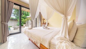 A bedroom with a large bed, a canopy, and a view of a garden through a glass door. - Serene 2BR Retreat w Pool & Lounge, Canggu's Heart (Kuta Utara)