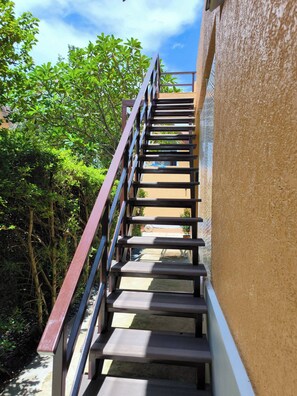 A staircase with metal railings leading to a building.
