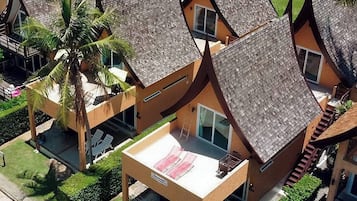A resort with multiple bungalow-style buildings, each with a sloped roof and a balcony.