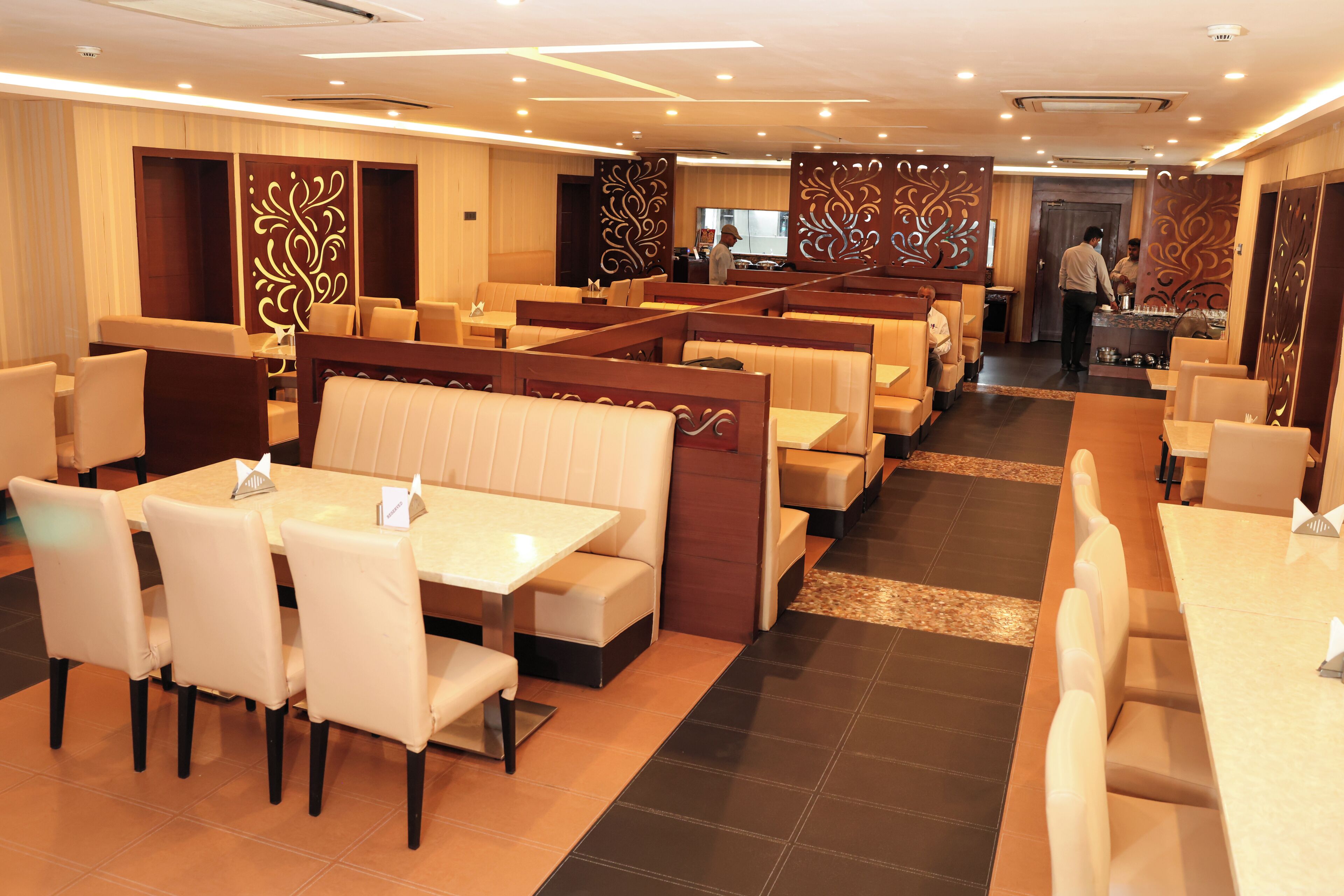 A restaurant with booths and tables, a bar area, and a counter.