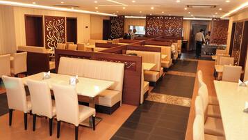 A restaurant with booths and tables, a bar area, and a counter.