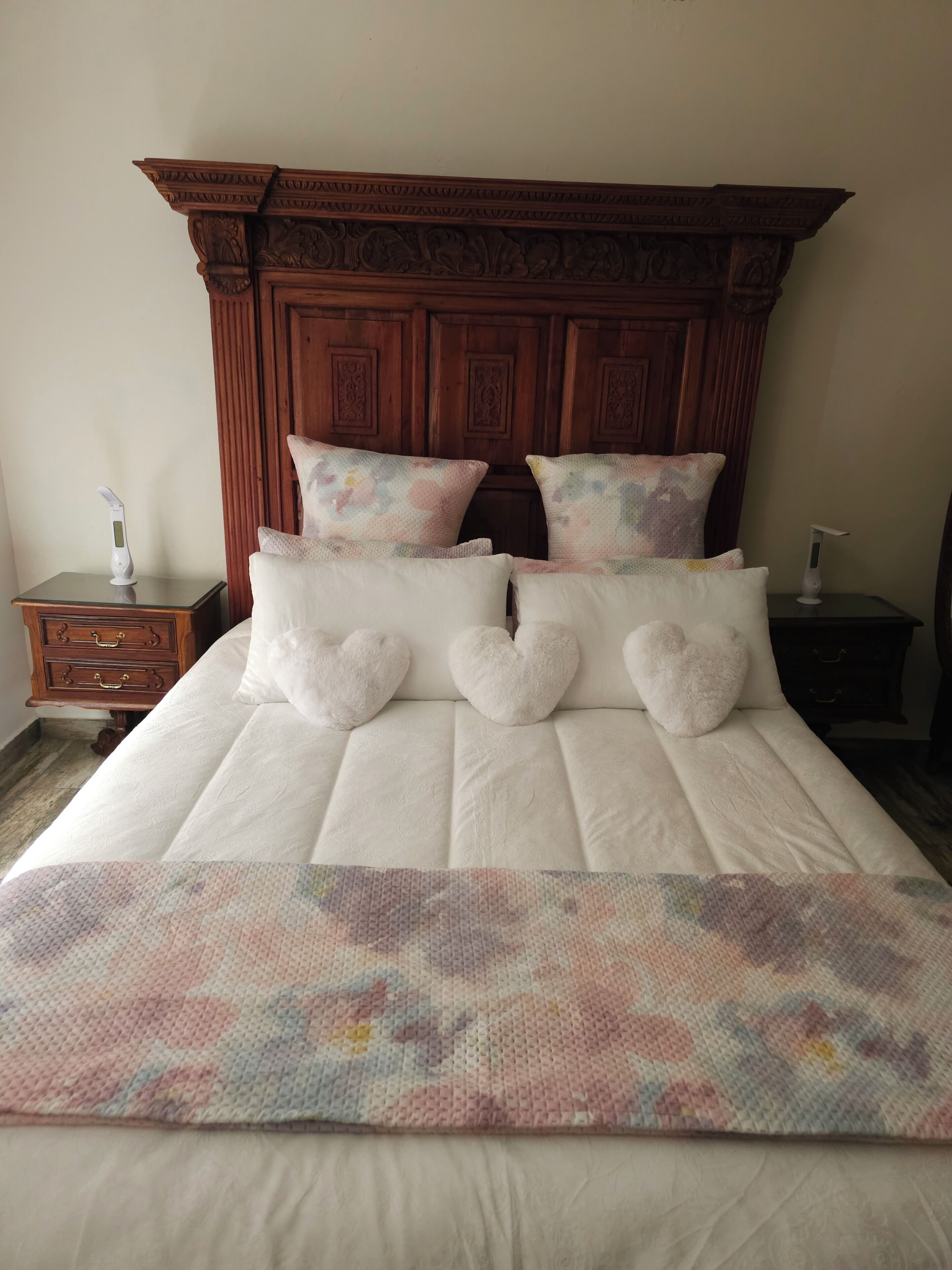 A bed with a quilt, pillows, and a wooden headboard.