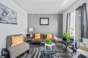 A modern living room with a sofa, coffee table, and decorative pillows.