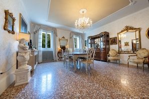 A spacious room with a large chandelier, ornate furniture, and a polished stone floor. - HISTORIC COUNTRY ESTATE — LUXURY AND RELAXATION — SWIMMING POOL — HOT TUB — PET-FRIENDLY (Veneto)