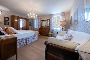A bedroom with a bed, a sofa, a dresser, a chair, and a mirror. - HISTORIC COUNTRY ESTATE — LUXURY AND RELAXATION — SWIMMING POOL — HOT TUB — PET-FRIENDLY (Veneto)