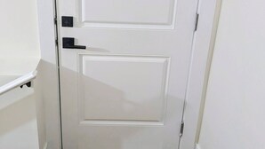 A white door with a doormat that reads 'Welcome.'