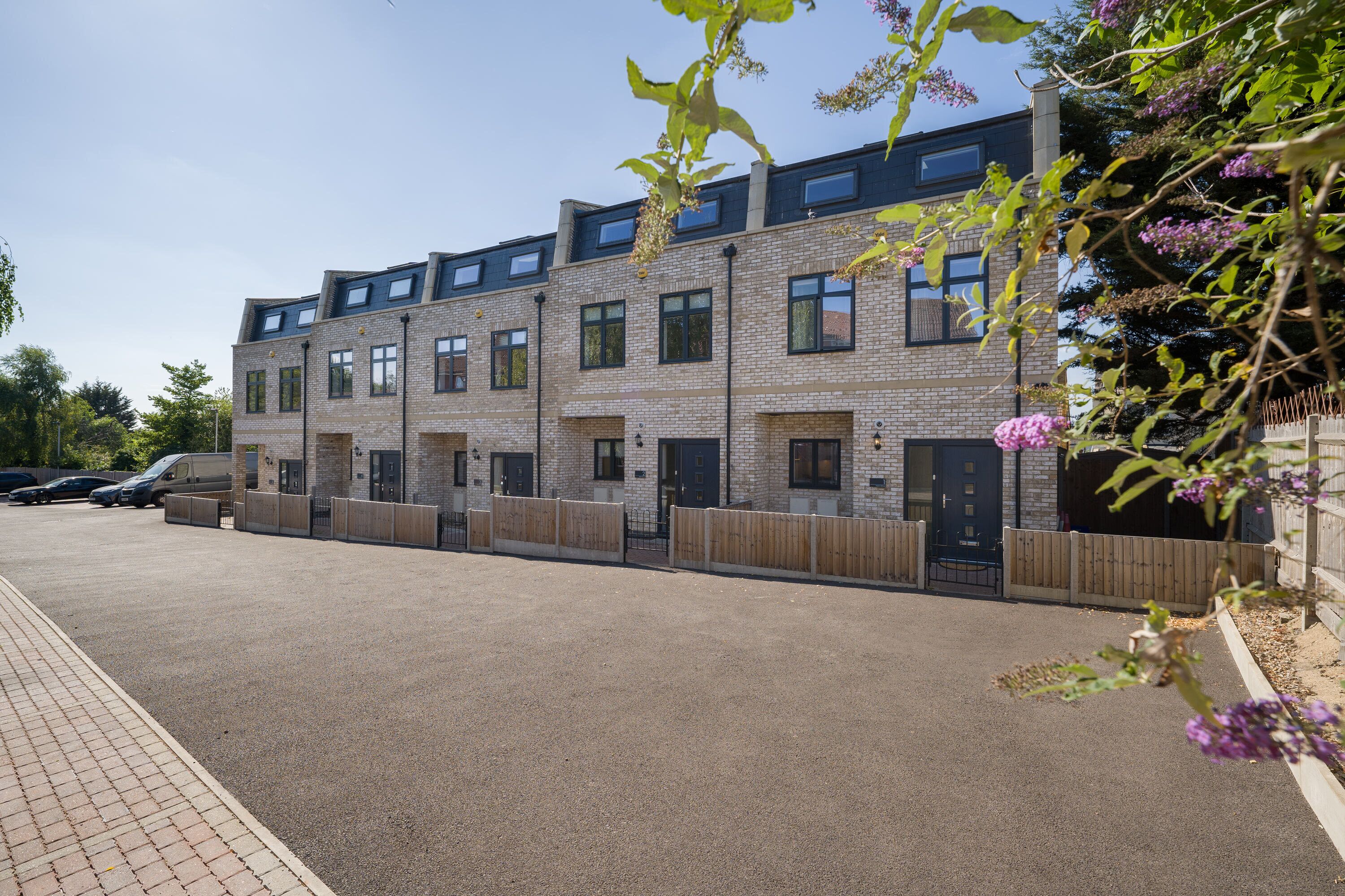 A modern multi-story residential building with a brick facade and multiple windows.