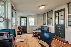 A room with a wooden table, chairs, a lamp, and a door with a window. - Quiet Dayton Monthly Retreat, Near Hospitals (Dayton)