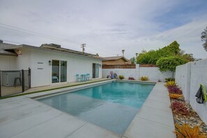 A residential swimming pool with a patio area, a covered patio, and a small garden with plants. - Grill & Fire Pit! Palm Desert Extended Escape (Palm Desert)