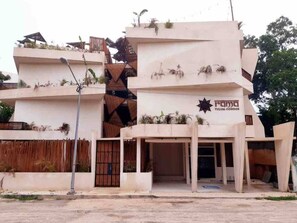 A modern building with a sign reading 'rama TULUM CONDOS'. - Condominium in Tulum, Mexico (Tulum)