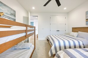Ein Schlafzimmer mit Etagenbetten, einer Tür und einem Bild an der Wand.