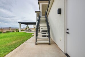 A staircase leading to a covered outdoor area with a view of a distant landscape.
