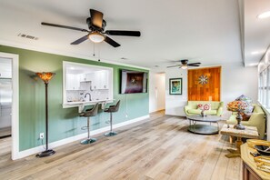A spacious living area with a kitchen, a dining area, and a seating space with a coffee table.