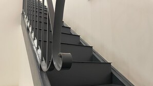 A modern staircase with a metal handrail and a black wall. - Arricriati near Ortigia by Wonderful Italy (Siracusa)