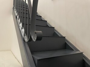 A modern staircase with a metal handrail and a black wall. - Arricriati near Ortigia by Wonderful Italy (Siracusa)