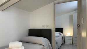 A modern bedroom with a single bed, a nightstand, and a wardrobe. - Arricriati near Ortigia by Wonderful Italy (Siracusa)
