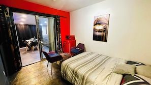 A hotel room with a bed, a chair, a small table, a red cabinet, and a sliding glass door leading to a balcony. - Luxury KIA house
Double room private
C3 (Richmond Hill)