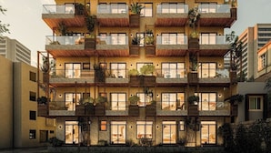A multi-story building with balconies, windows, and outdoor plants. - DaNy Living Thao Dien by DNM Hospitality (Ho Chi Minh City)