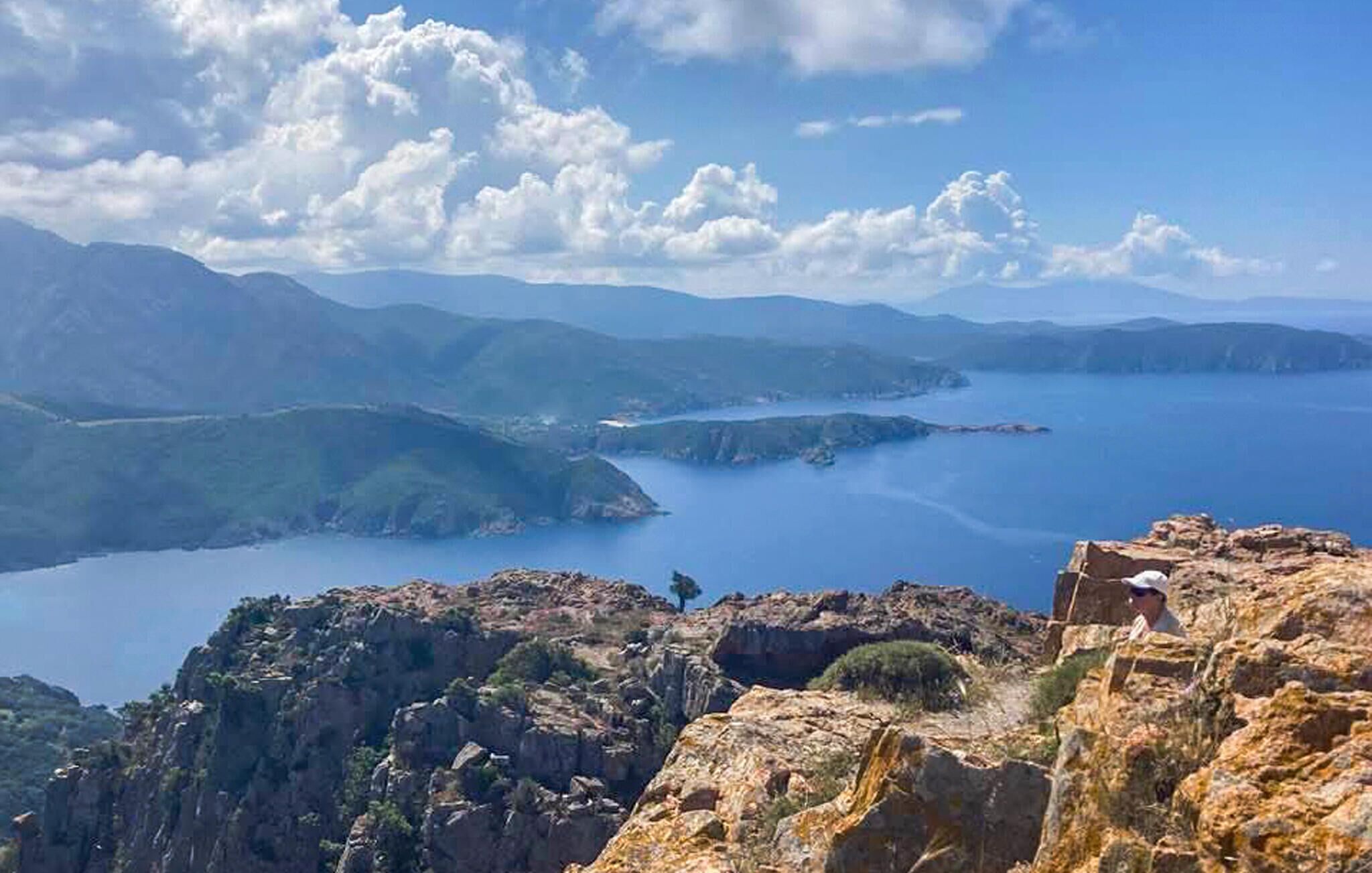A mountainous landscape with a clear sky and a body of water.