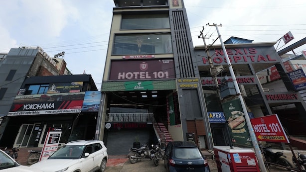 A multi-story building with a prominent sign for Hotel 101 on the ground floor.