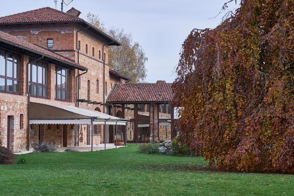 A brick building with multiple windows and a covered patio area.