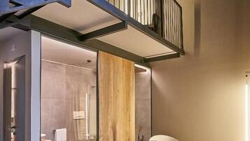 Une salle de bain moderne avec une baignoire sur pieds, une douche à parois de verre et un plancher en bois.