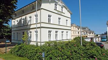 A multi-story building with a sign 'Villa Rosa' on the facade.