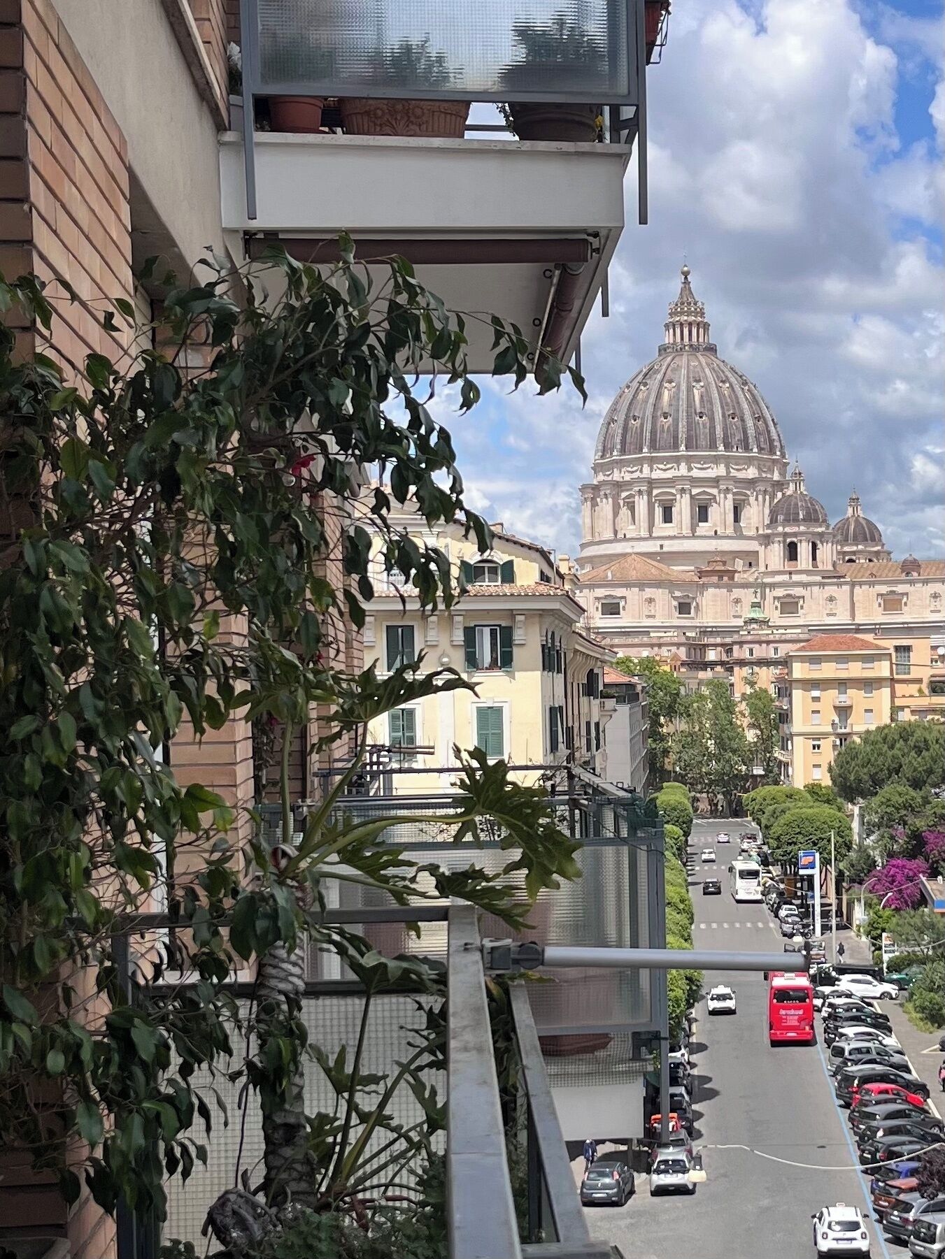 A street view with a large historical building with a dome in the background.