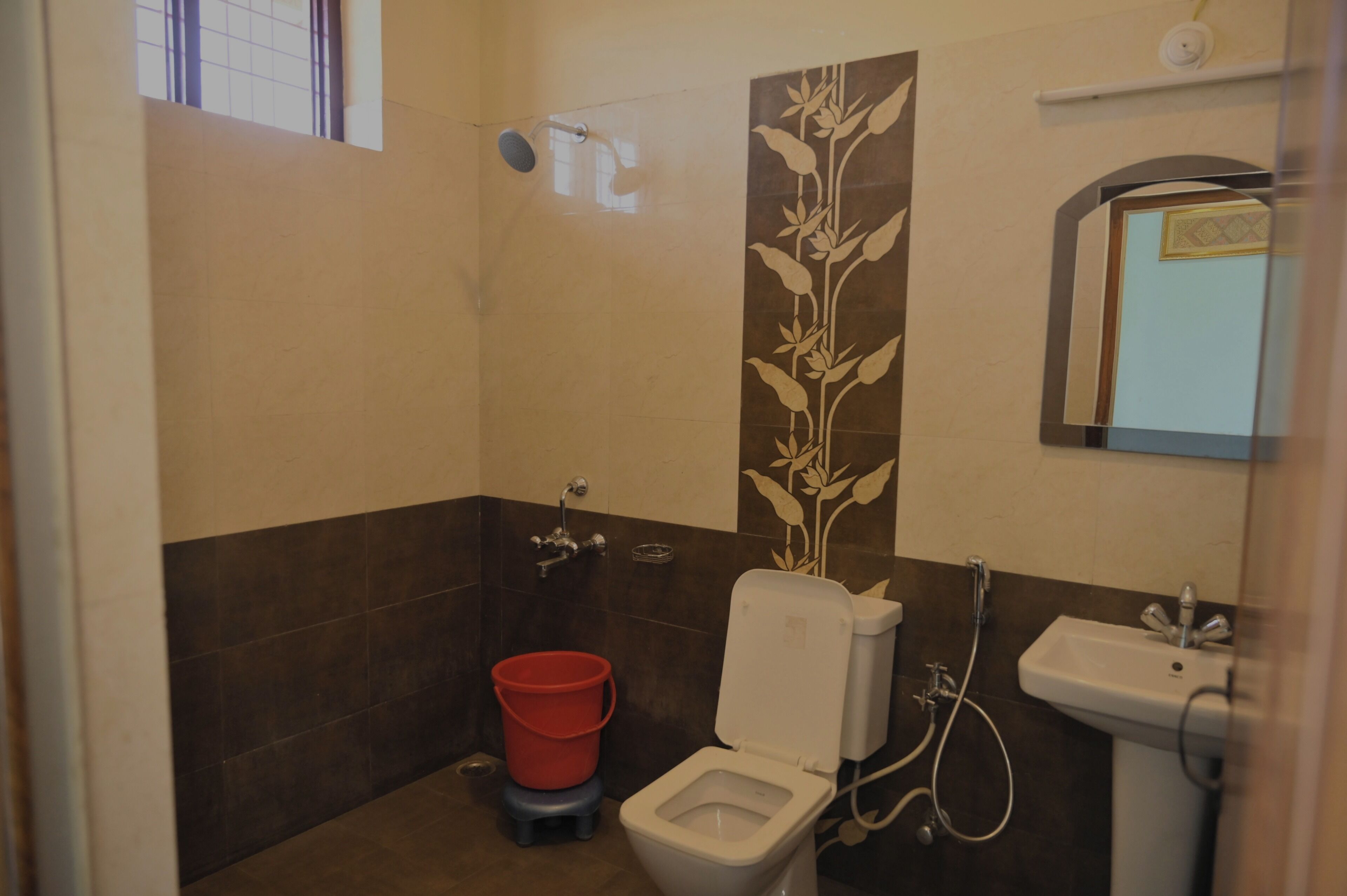 A bathroom with a toilet, bidet, and shower.