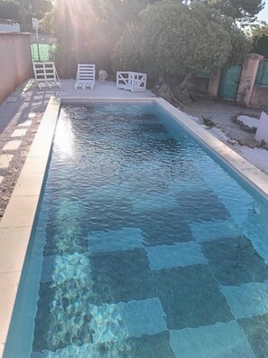 A rectangular swimming pool with clear water, surrounded by a paved deck and a low wall. - Villa Les Bonnes Herbes -- First floor, pool, hills, ocean -- 4 stars (Toulon)