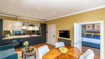 A modern living space with a kitchen, dining area, and bedroom.