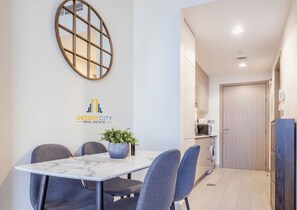 A modern kitchen with a microwave, oven, and cabinets. - Close to Carrefour Supermarket | Calm location (Dubai)