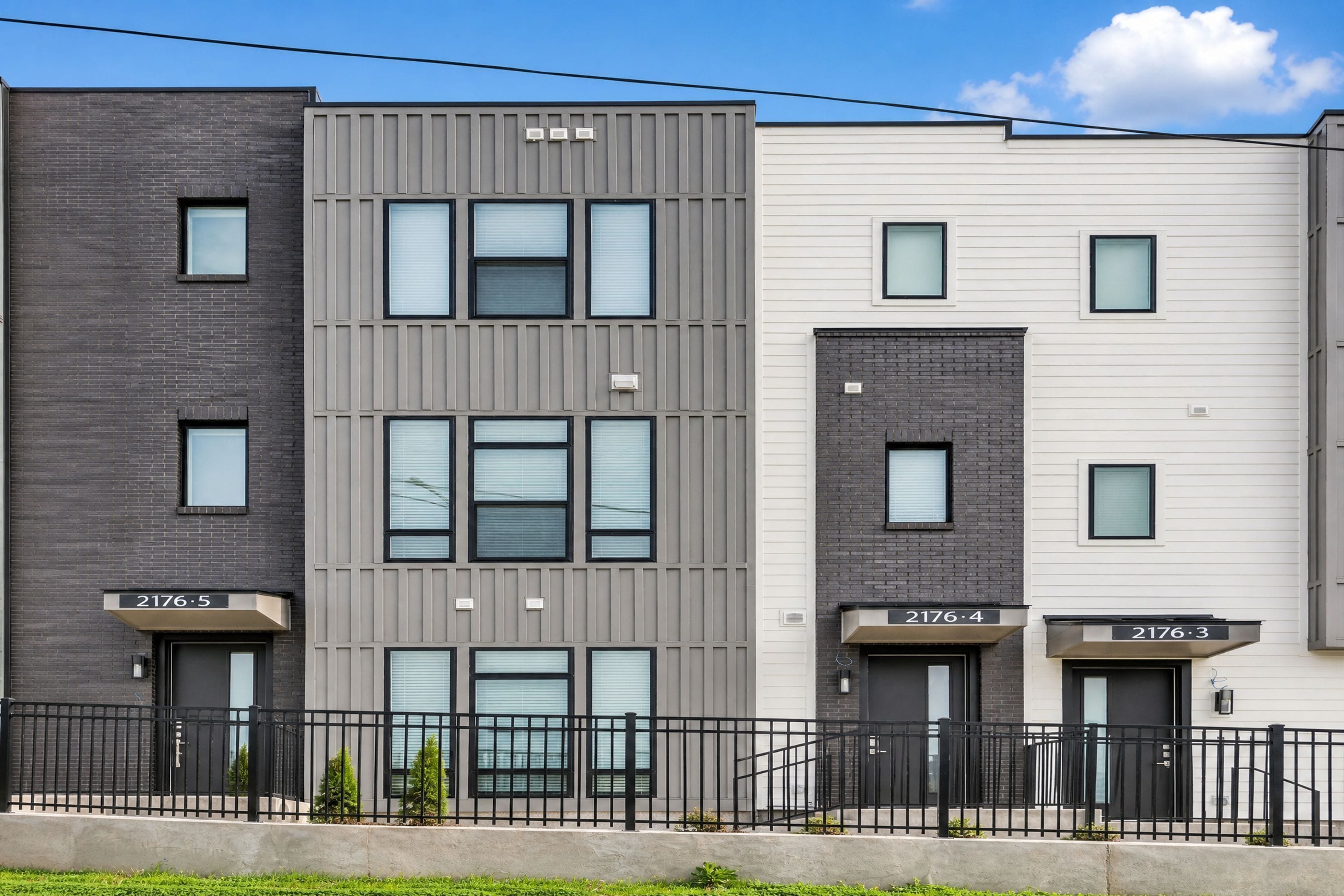 A multi-story residential building with numbered units 2176-5, 2176-4, and 2176-3.
