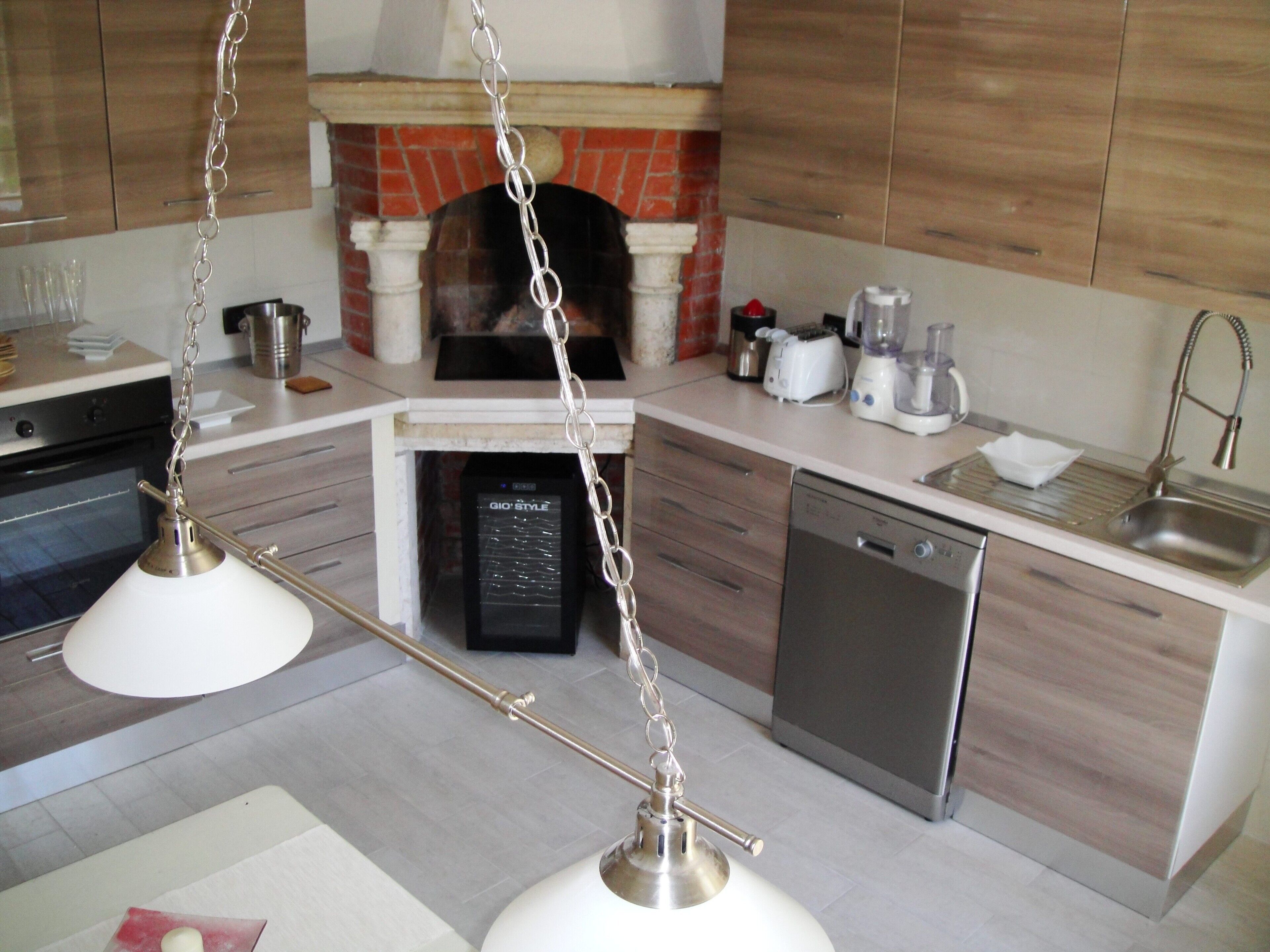 A modern kitchen with a dishwasher, oven, and a built-in stove.