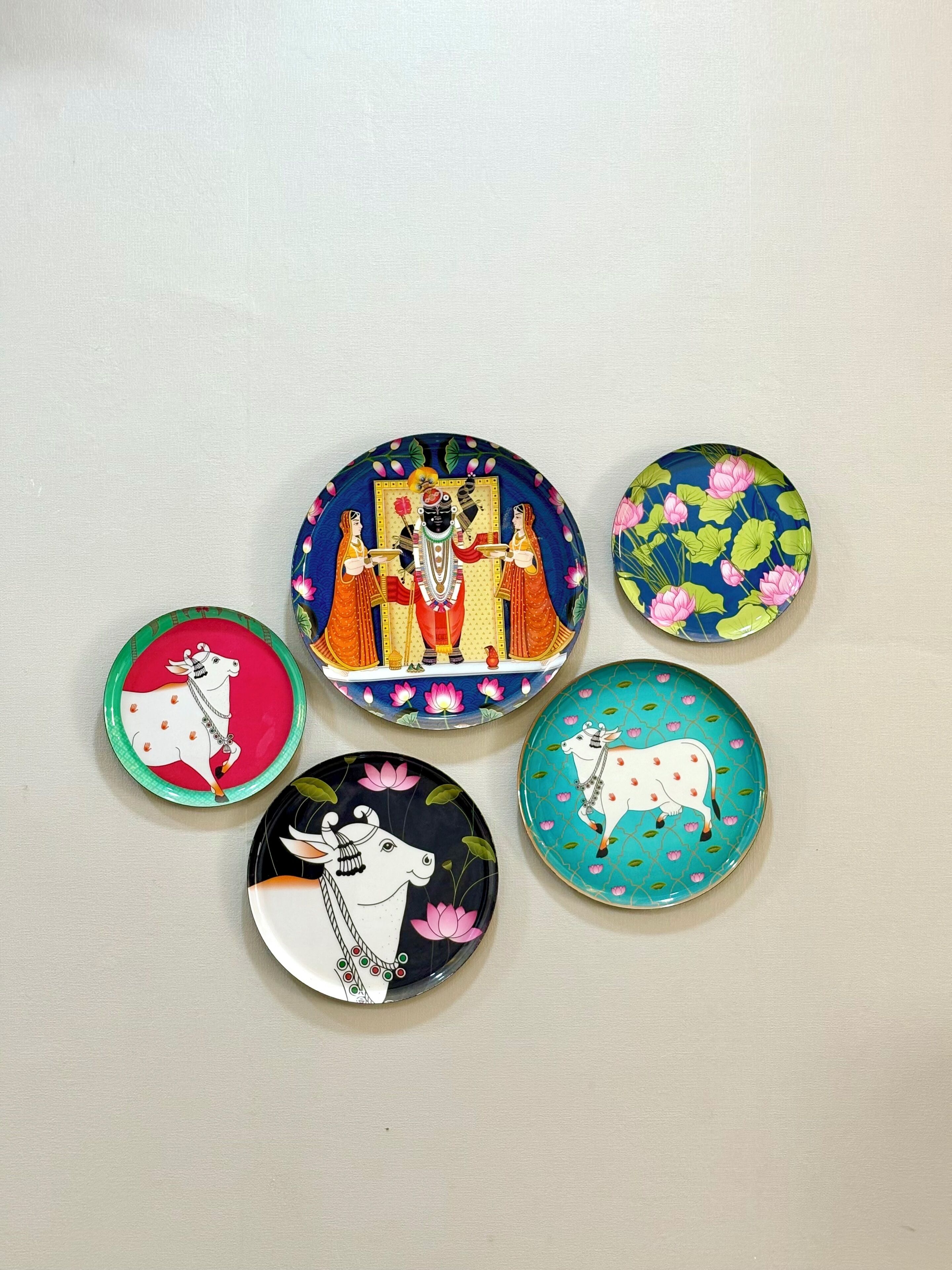 Five round plates with various designs.