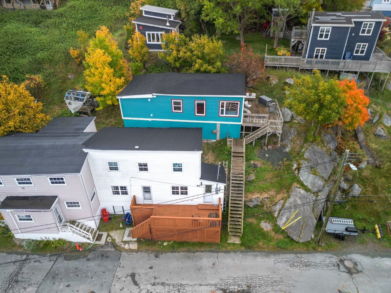 A residential area with houses, a wooden staircase, and a small dock.
