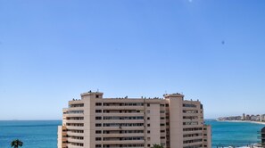A multi-story building with a flat roof and numerous windows, overlooking a beach and ocean. - Ref: 287. Fantastic 3 bedroom apartment near the sea (Fuengirola)