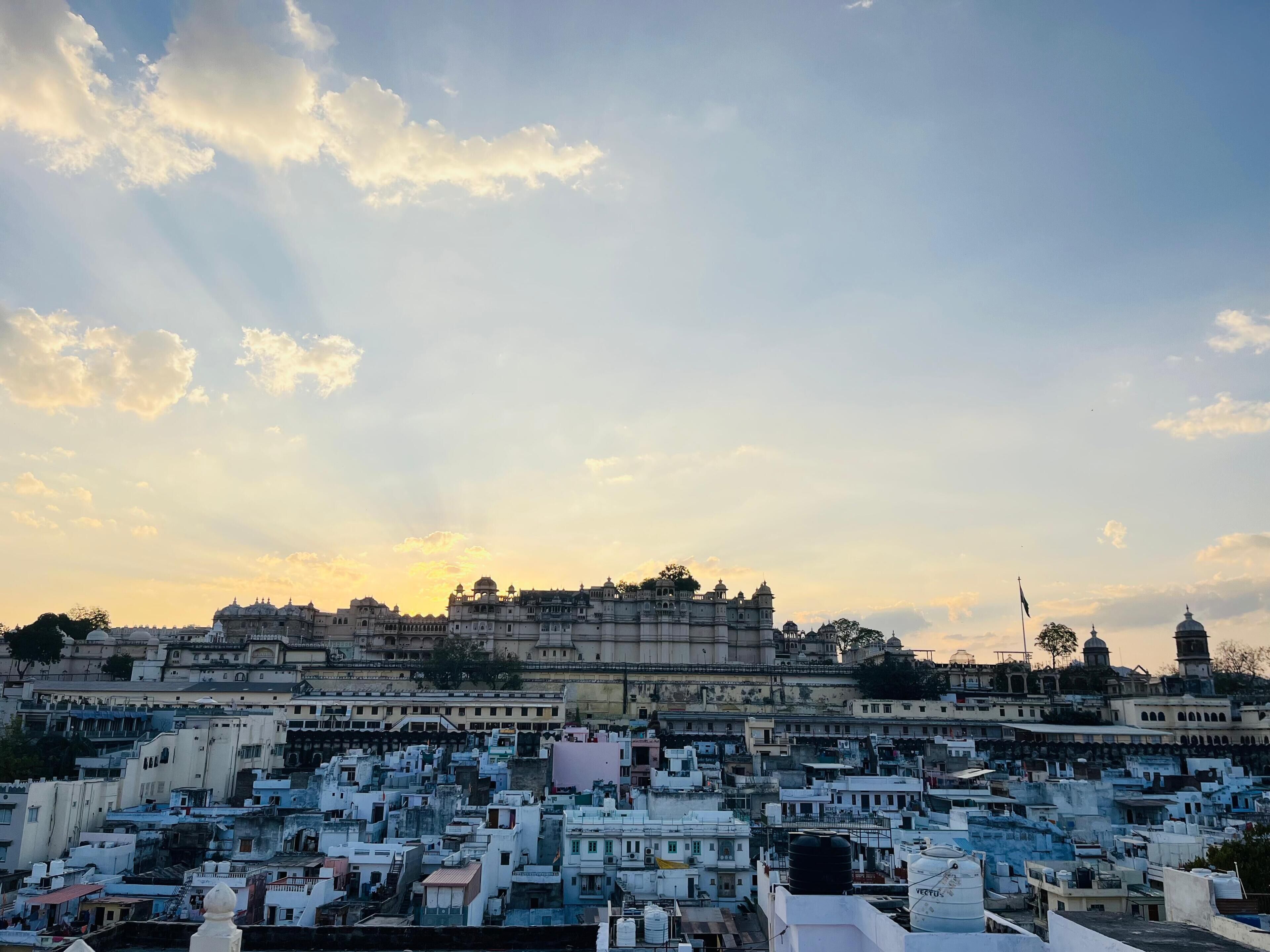 A cityscape with a prominent historical building and densely packed residential structures.