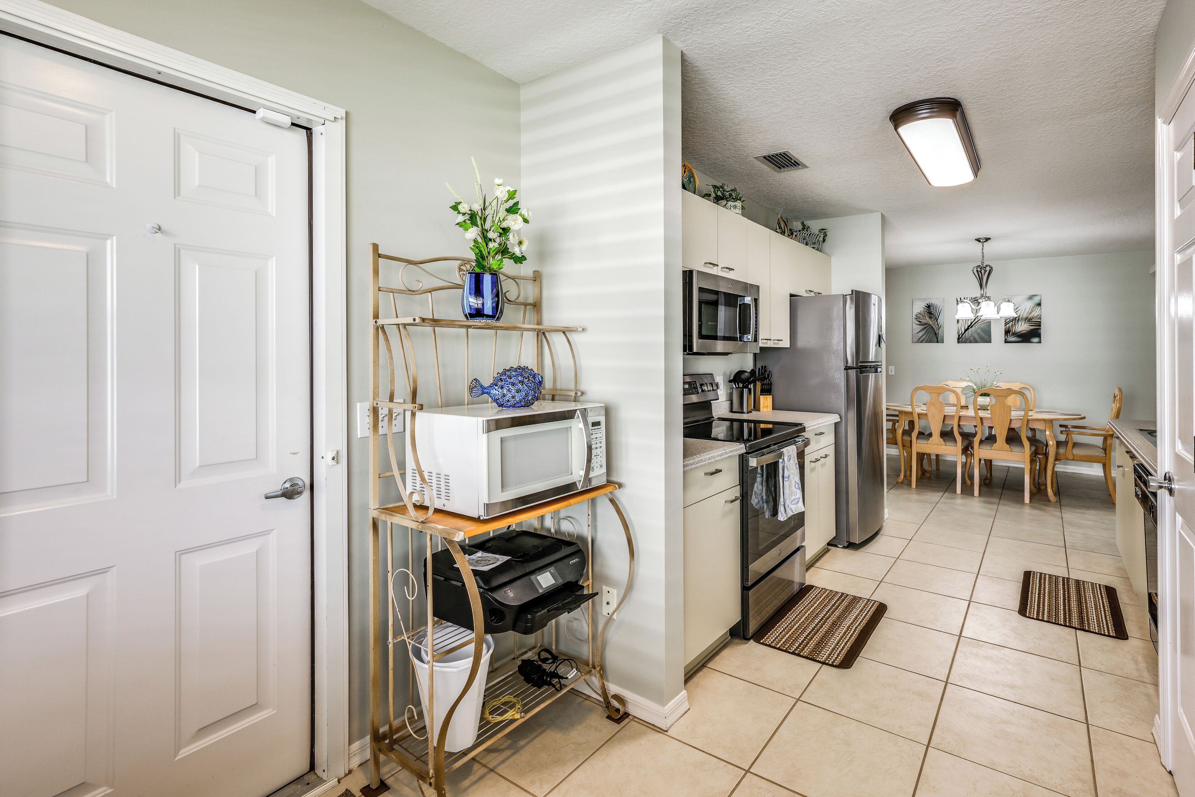 A compact kitchen with a microwave, oven, and refrigerator.