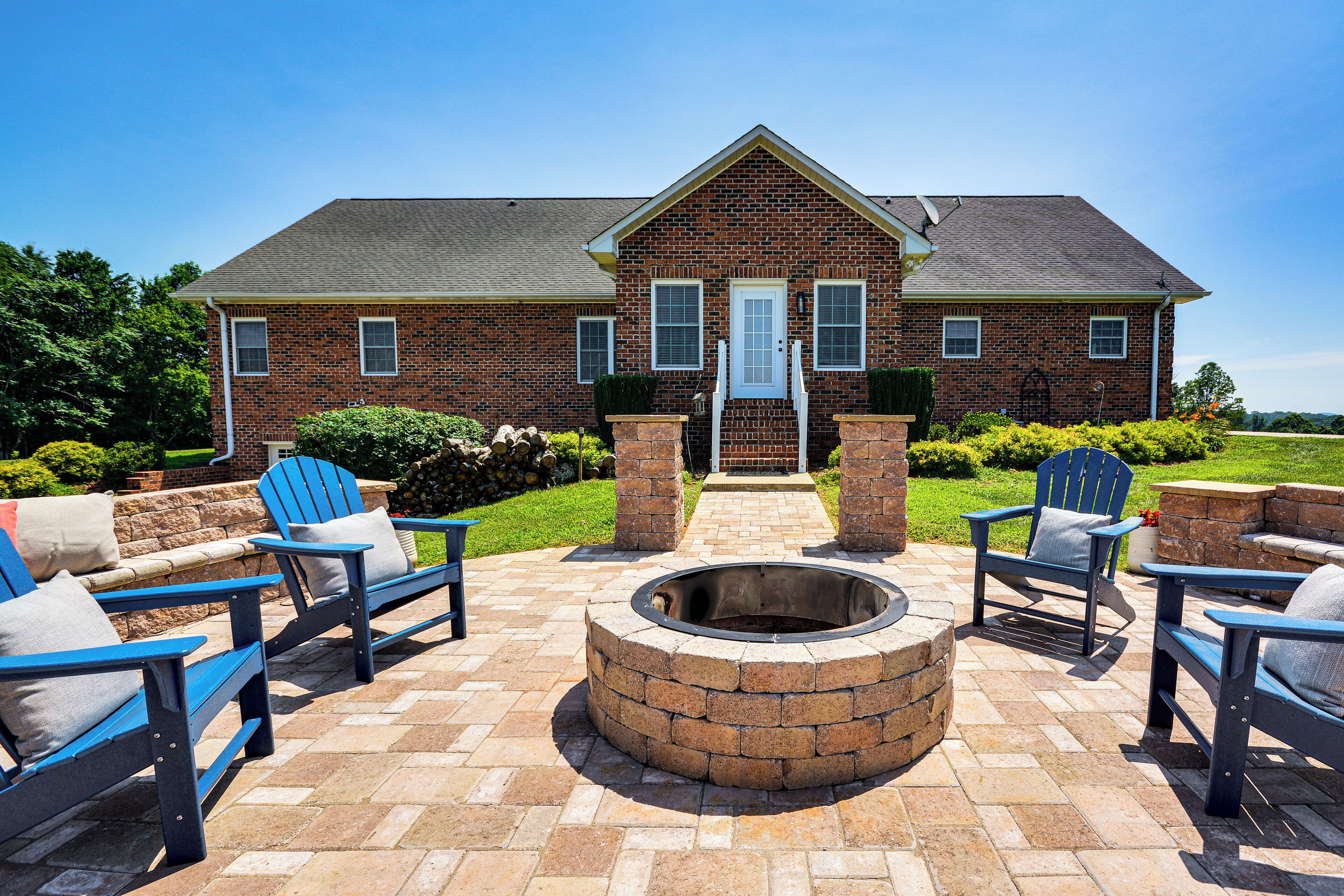 A brick house with a fire pit and outdoor seating.