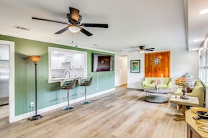 A spacious living area with a kitchen, a dining area, and a seating space with a coffee table. - Great for Families! Dothan Getaway w/ Large Yard (Dothan)