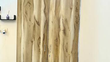 A wardrobe with a wood grain design, two doors, and a handle on each door.